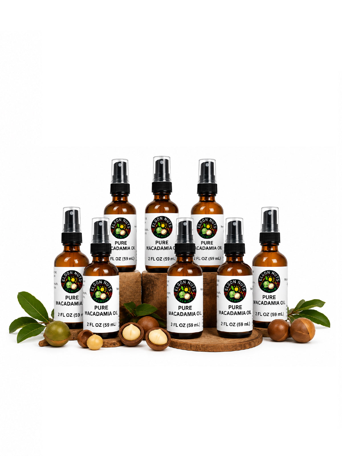 Eight Elgon Nuts pure macadamia oil 2 fl oz spray bottles displayed on wooden stands with fresh macadamia nuts and leaves.