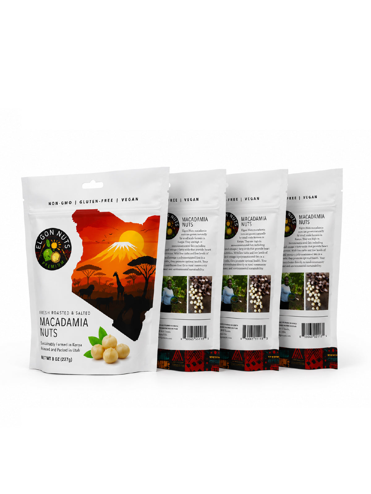 Four 8 oz bags of Elgon Nuts roasted and salted macadamia nuts with front and back packaging displayed.