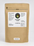 A 2 lb bag of Elgon Nuts Macadamia Flour in a brown kraft paper stand-up pouch with a white label, photographed against a clean white background