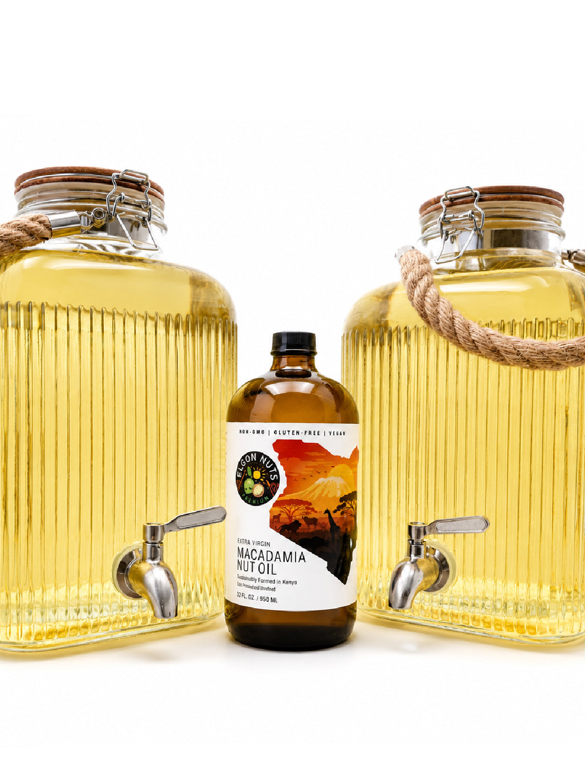 Elgon Nuts macadamia nut oil bottle displayed between two large glass dispensers filled with golden cooking oil.