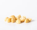 Style 4S raw macadamia nuts featuring small halves and broken pieces on a white background.