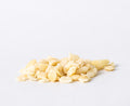 Style 6 raw macadamia nuts featuring small chopped macadamia pieces on a white background.